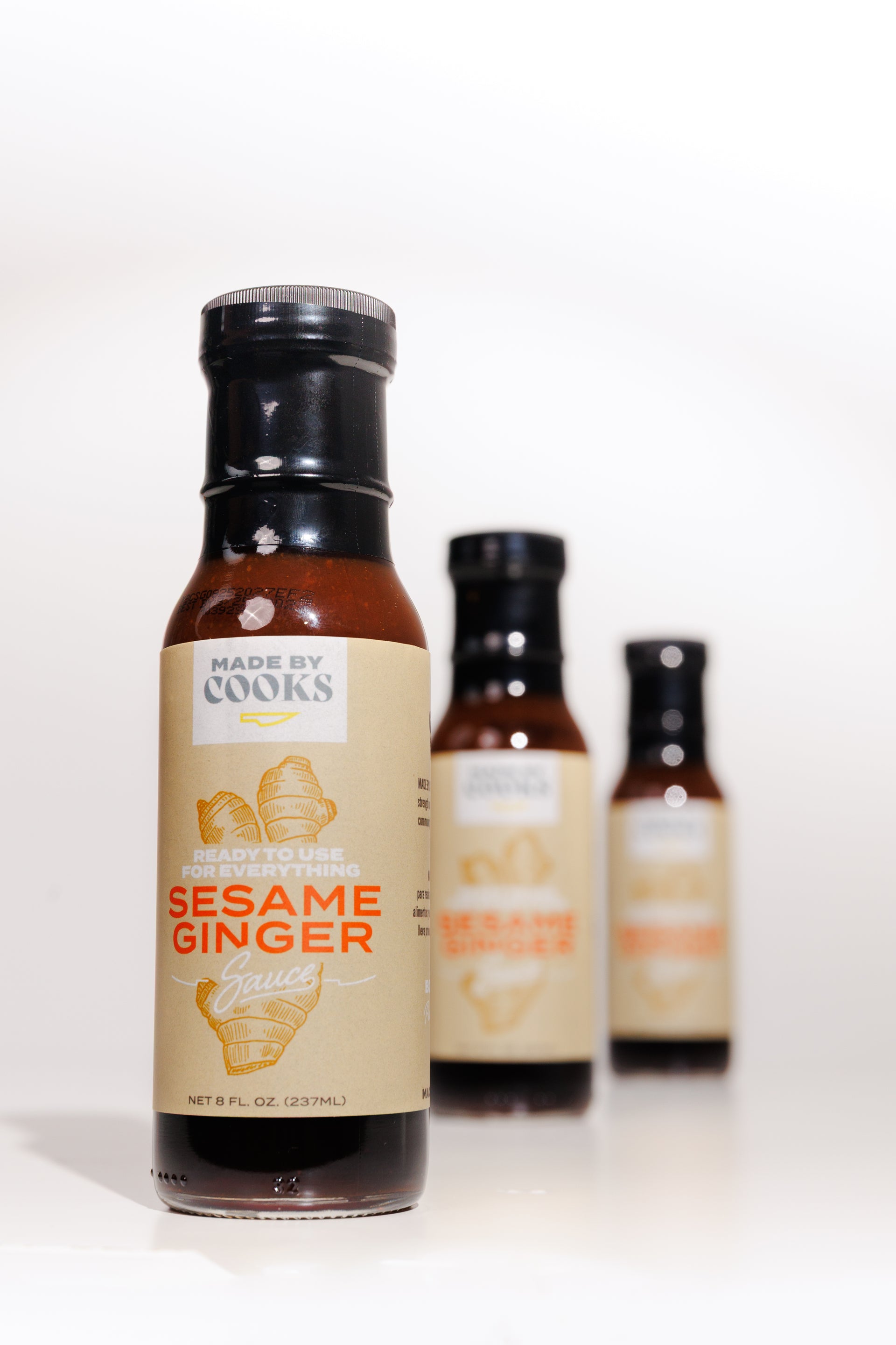 Three bottles of Made By Cooks sesame and ginger sauce – versatile marinade, dressing, and dipping sauce