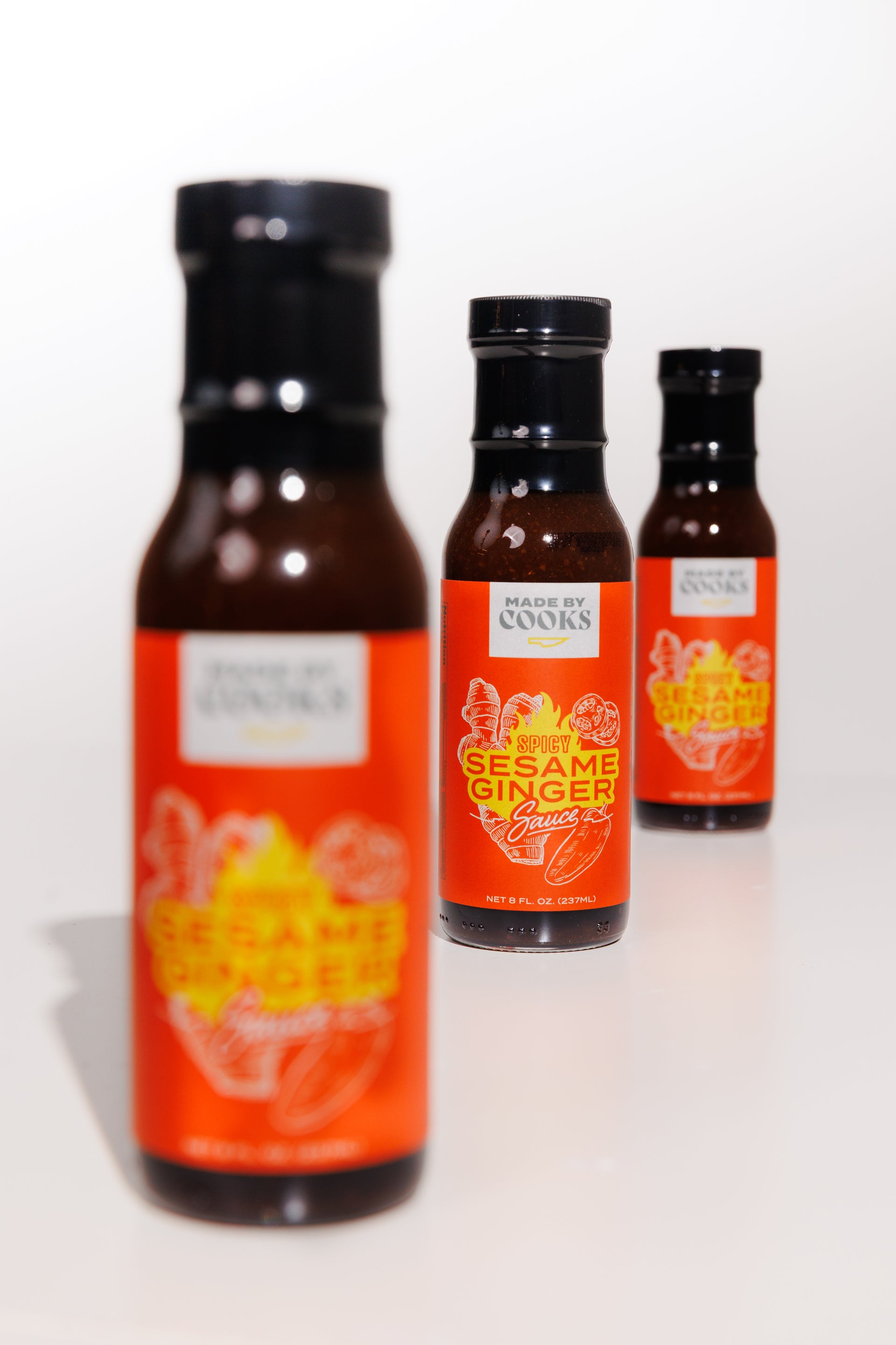 Three bottles of spicy sesame and ginger habanero sauce by Made By Cooks